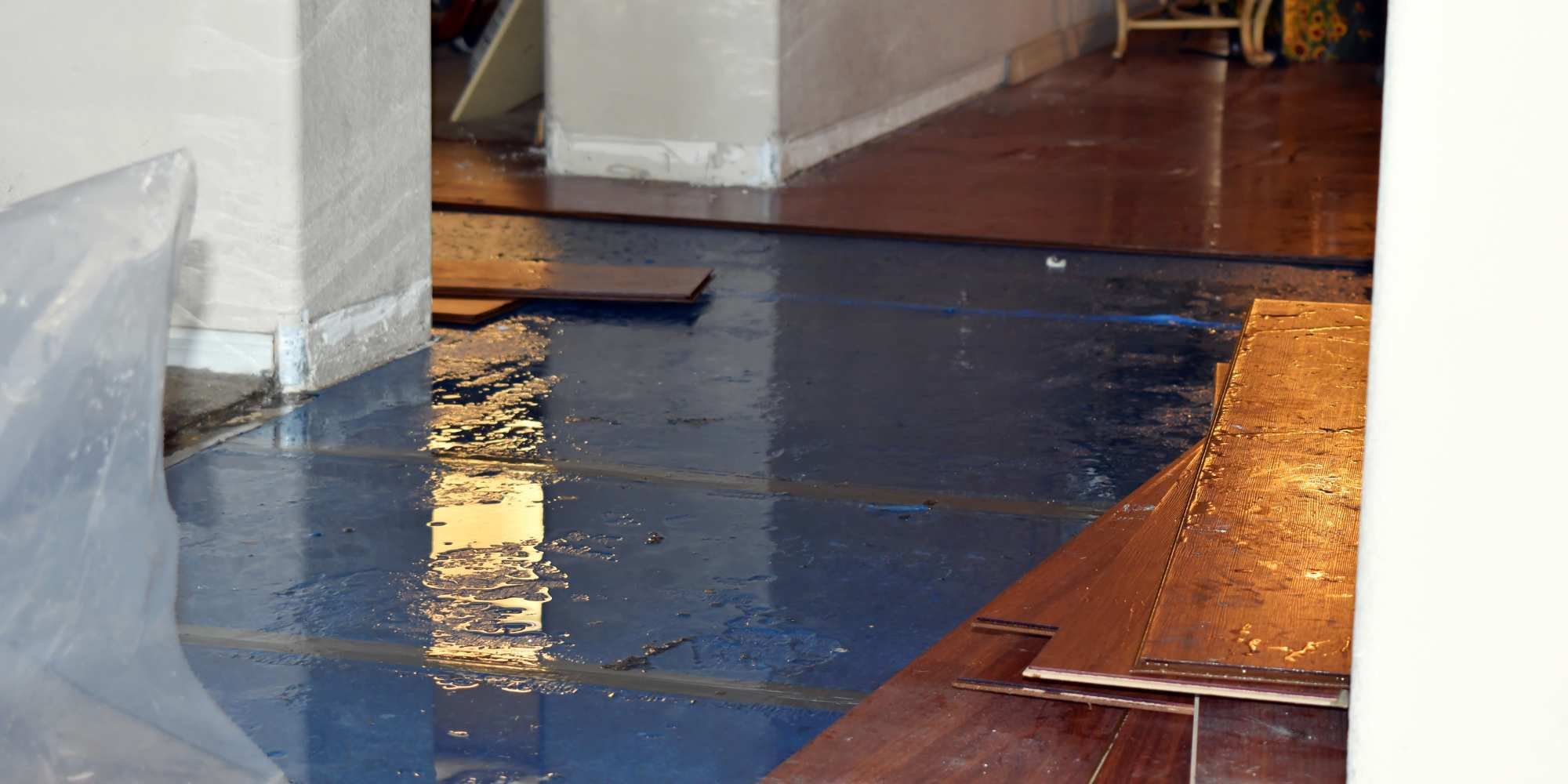 Stock image of water damage on a floor with boards removed in Reno, NV
