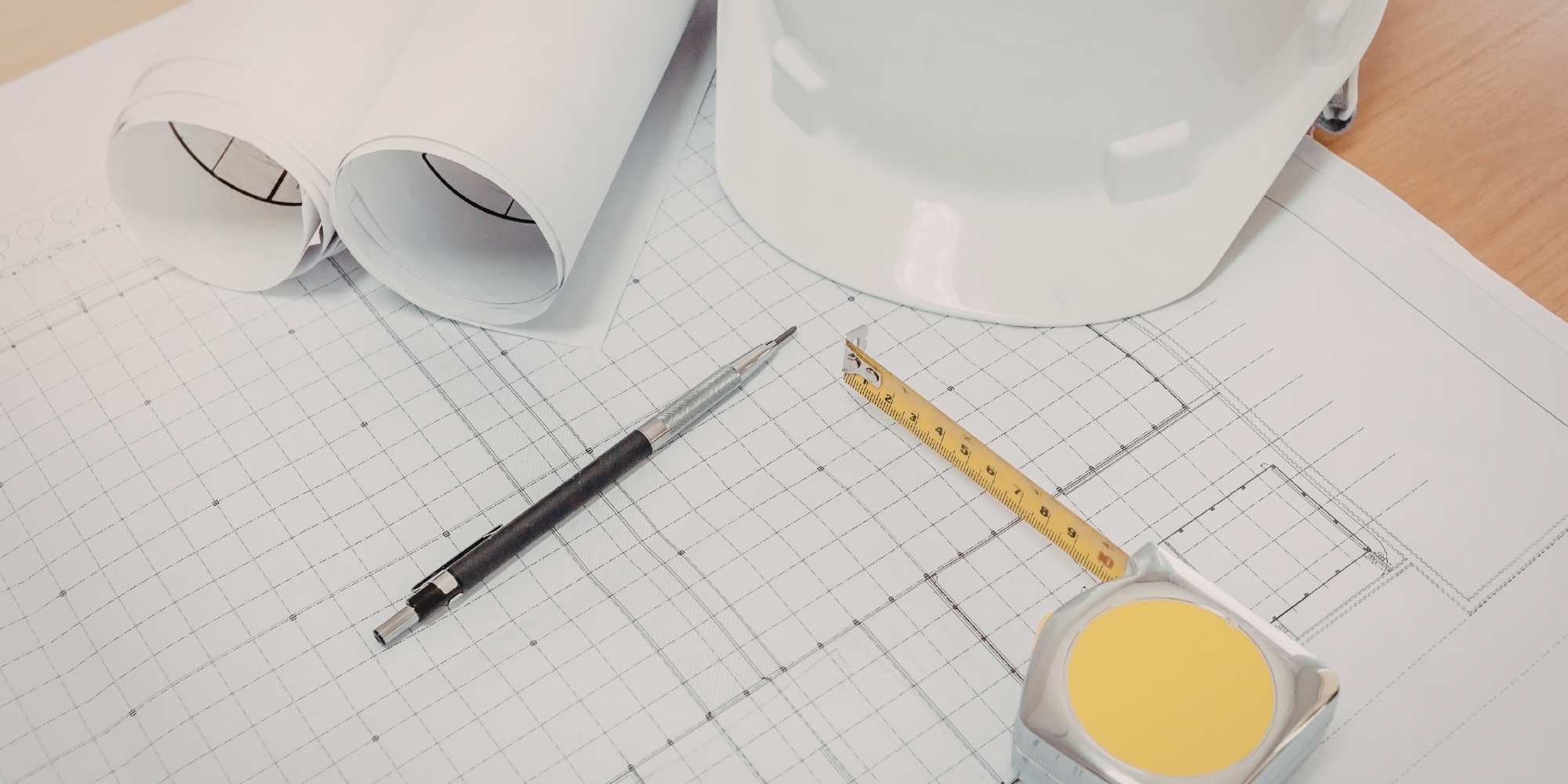 Stock Image of a hard hat, grid, pencil, and a tape measurer to plan a kitchen remodel in Reno, NV