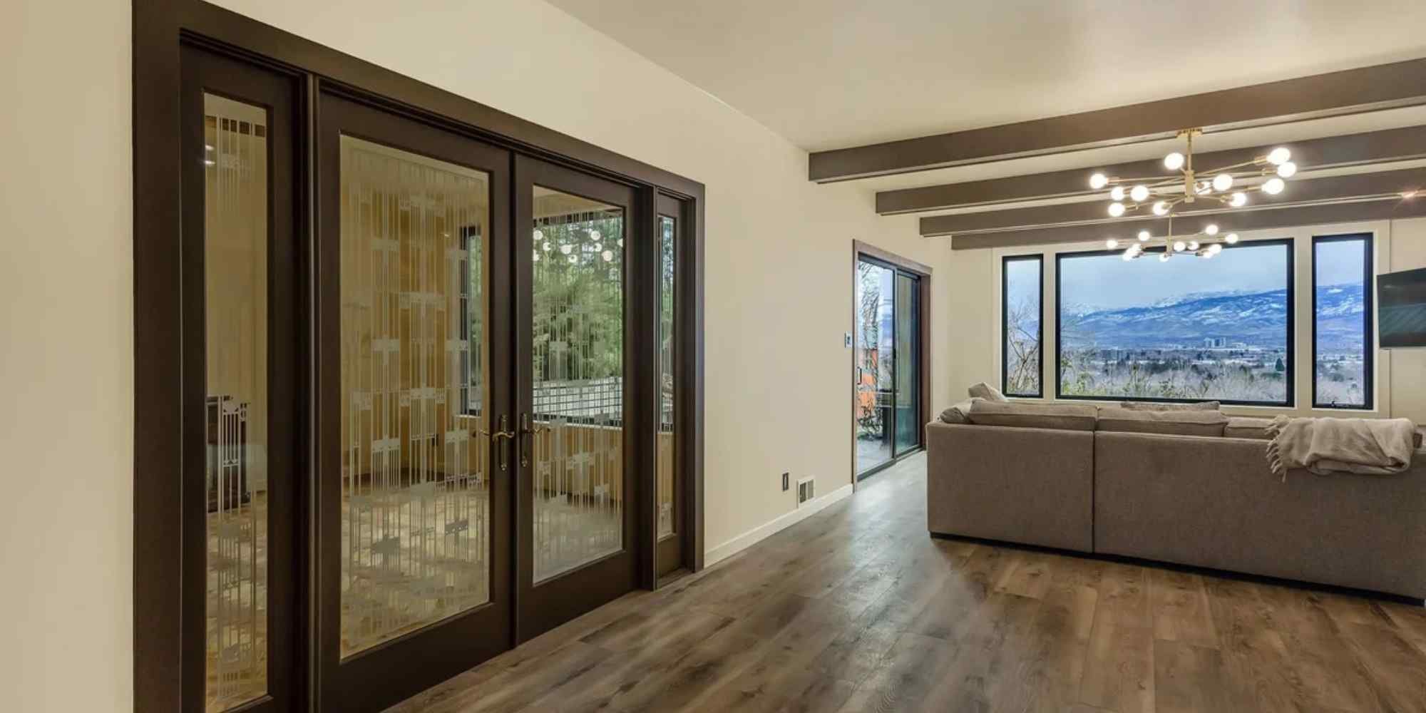 Image of the living room with wood floors and wood beams in a remodeled home by M and G Construction in Reno