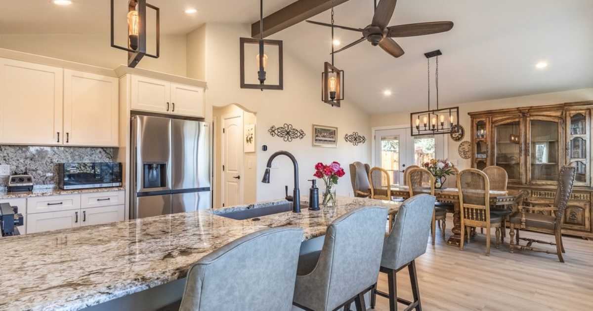 M&G Construction kitchen remodel in Reno, NV featuring granite island, open dining layout, and modern farmhouse lighting