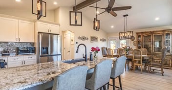 M&G Construction kitchen remodel in Reno, NV featuring granite island, open dining layout, and modern farmhouse lighting