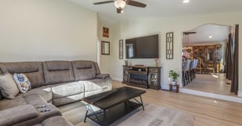 Image of a remodeled living room with arch doorway leading to kitchen in Reno, NV by M&G Construction