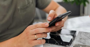 Stock photo of a person using their phone to find how long a remodel takes in Reno, NV
