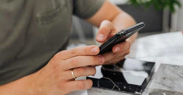 Stock photo of a person using their phone to find how long a remodel takes in Reno, NV