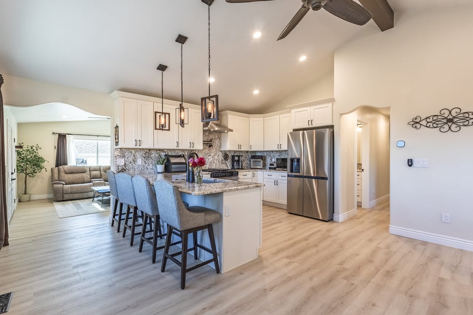 Contemporary kitchen with white cabinets and granite countertops in M&G Construction’s custom Reno home.